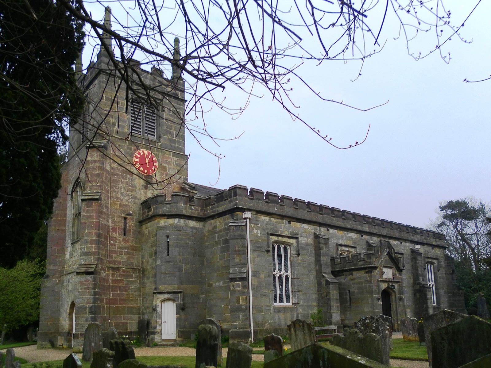 St Alban’s Church, Frant, a sandstone Gothic church with a battlemented tower, seen from the churchyard.